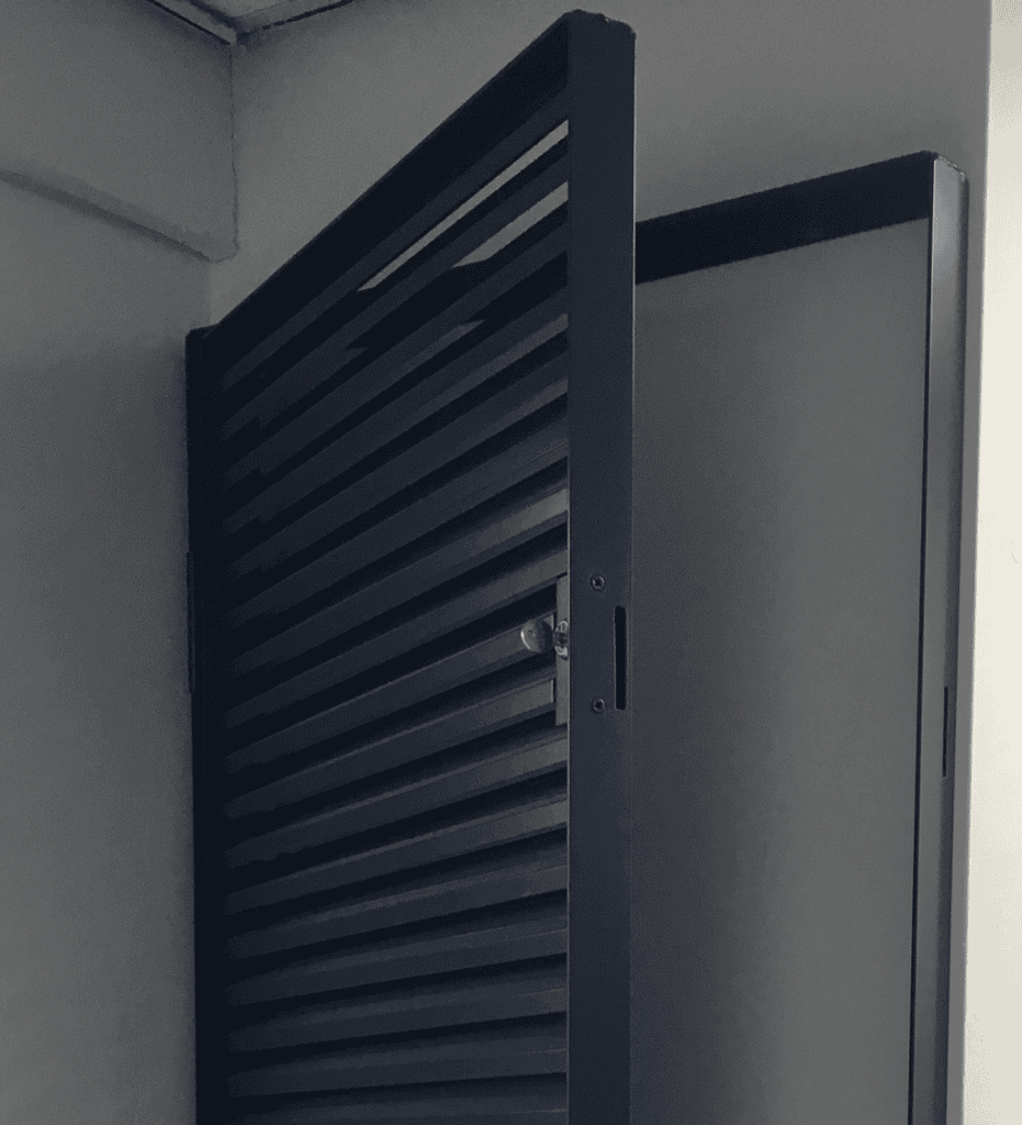 Installed IKL33 hinged aluminium louvre panel in open position showing side hung access door and horizontal blade arrangement